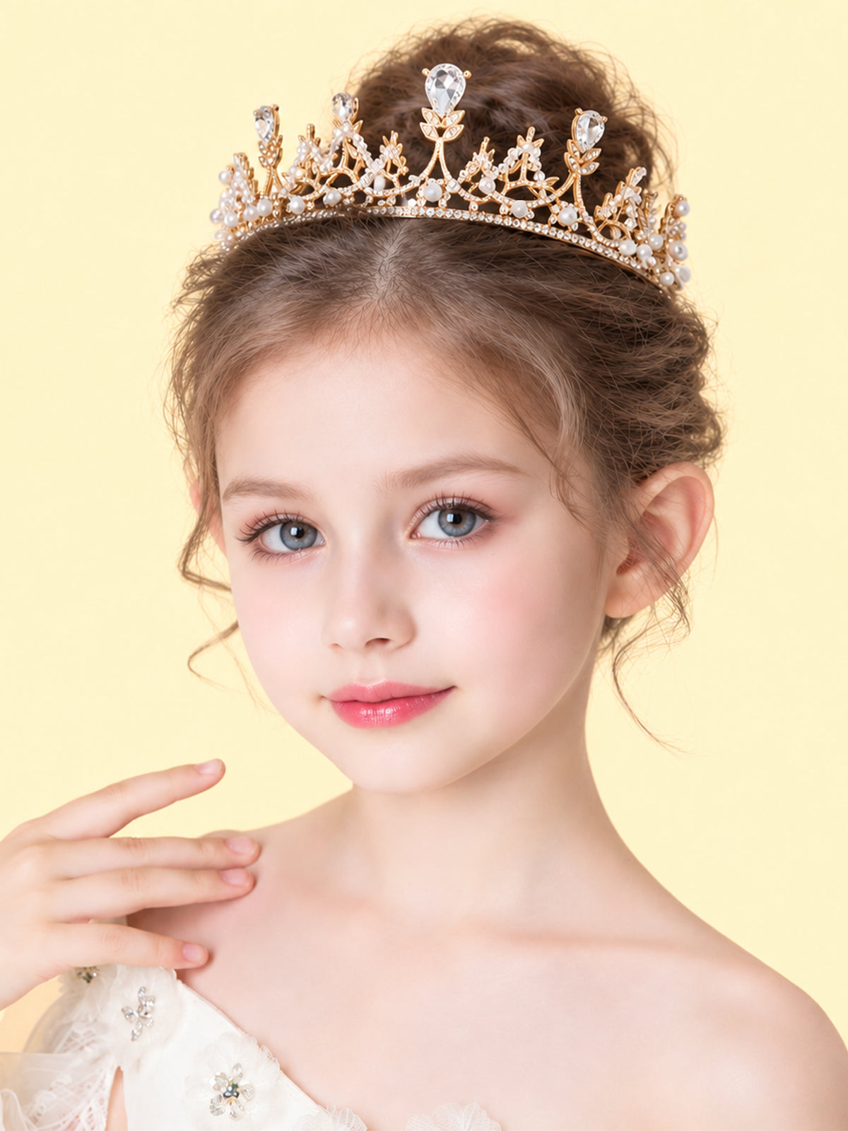 Blisseven girls gold rhinestone pearl princess crown tiara worn by model, elegant hair accessory for birthday, wedding, pageant, and photoshoot styling