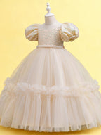 Blisseven champagne girls party dress angled view showing the puff sleeves and ruffled tulle skirt