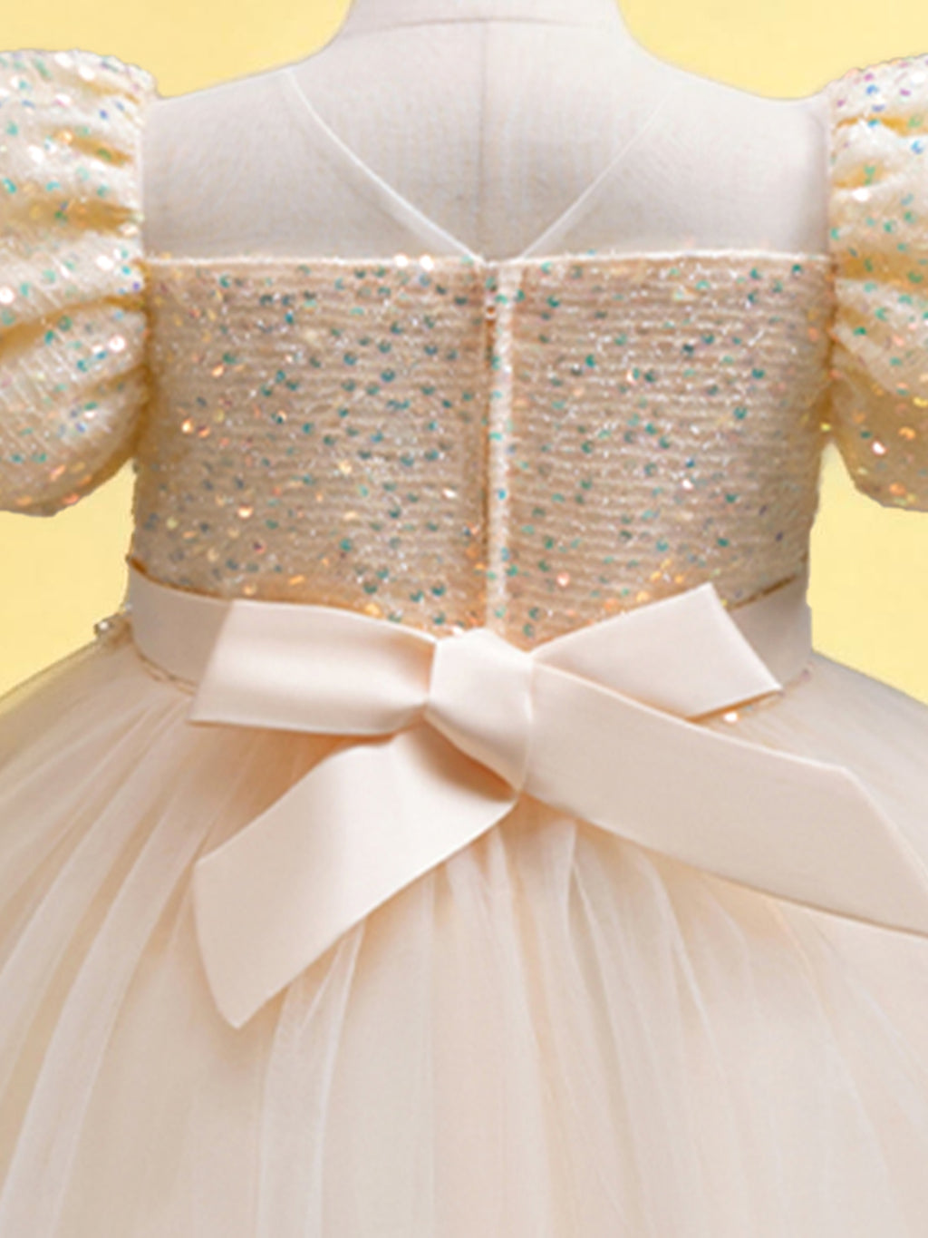 Blisseven champagne girls party dress close-up of the back bow and sequin bodice