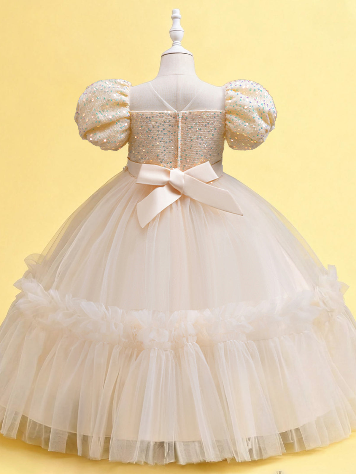 Blisseven champagne girls party dress back view showing the statement bow and zipper closure
