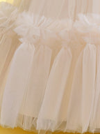Blisseven champagne girls party dress close-up of the tulle skirt and ruffle accents