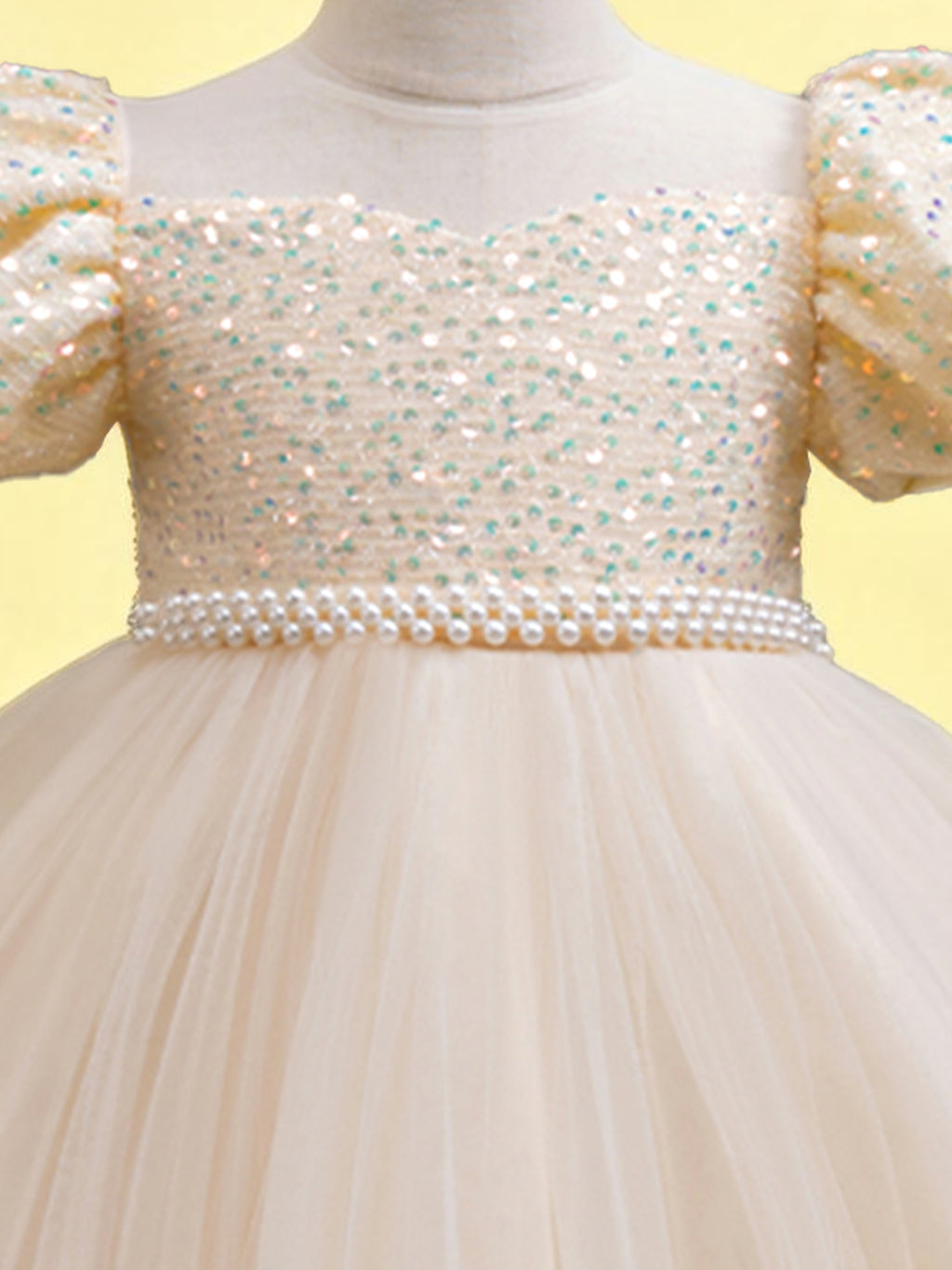 Blisseven champagne girls party dress close-up of the sequin bodice and decorative waist trim