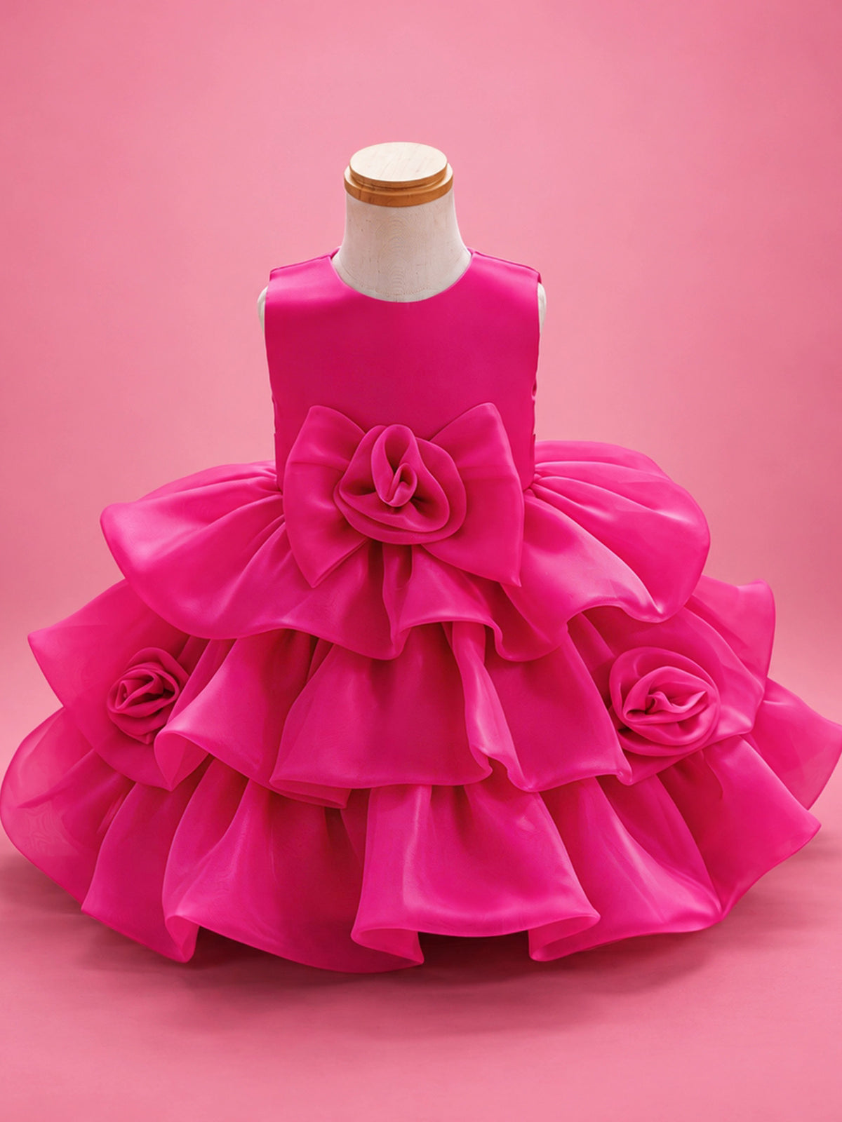 Blisseven LS8609 hot pink girls organza tiered short princess dress front view, featuring a fluffy layered skirt, large 3D floral bow at the waist, and small flower details on the skirt
