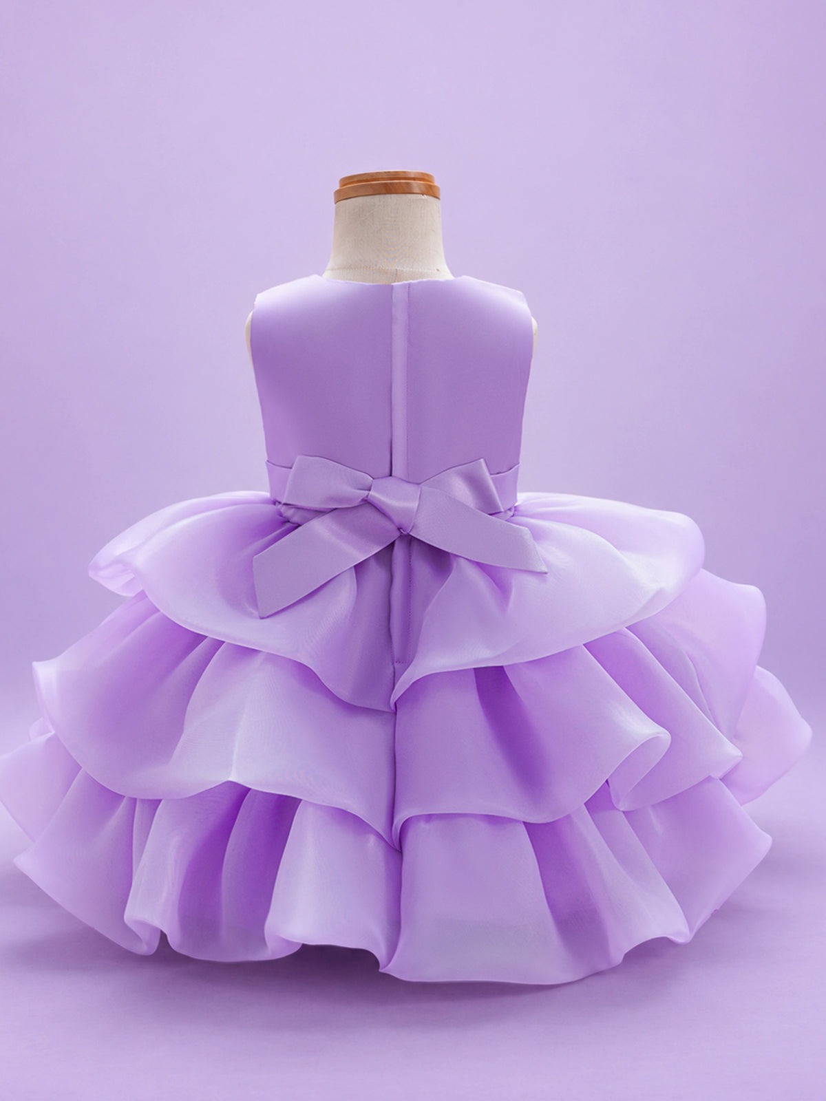 Blisseven LS8609 lavender girls organza tiered short princess dress back view, featuring a smooth satin bodice, back bow, zipper closure, and layered organza skirt