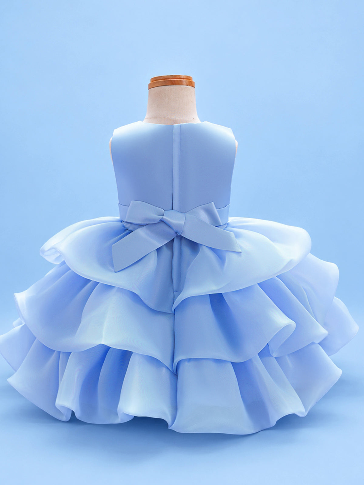 Blisseven LS8609 sky blue girls organza tiered short princess dress back view, featuring a smooth satin bodice, back bow, zipper closure, and layered organza skirt