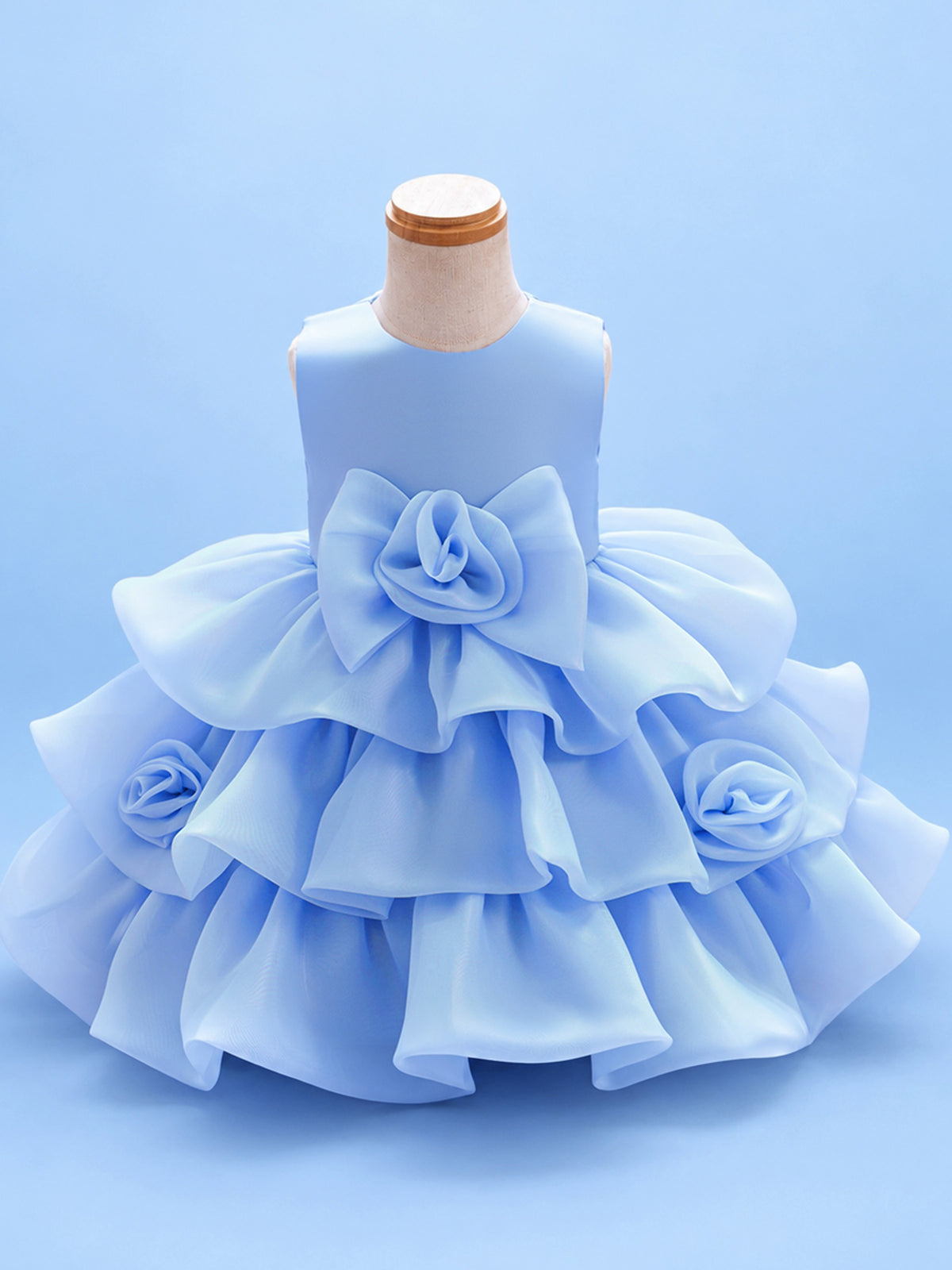 Blisseven LS8609 sky blue girls organza tiered short princess dress front view, featuring a fluffy layered skirt, large 3D floral bow at the waist, and small flower details on the skirt