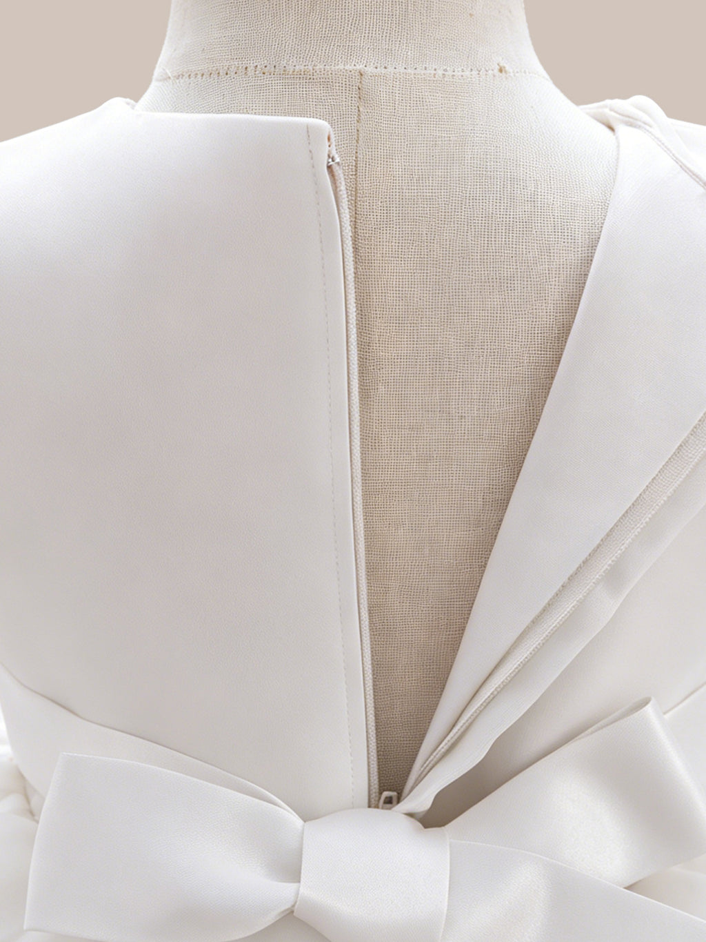 Blisseven LS8609 white girls princess dress back zipper detail, showing the smooth satin back bodice, zipper closure, and bow tie design