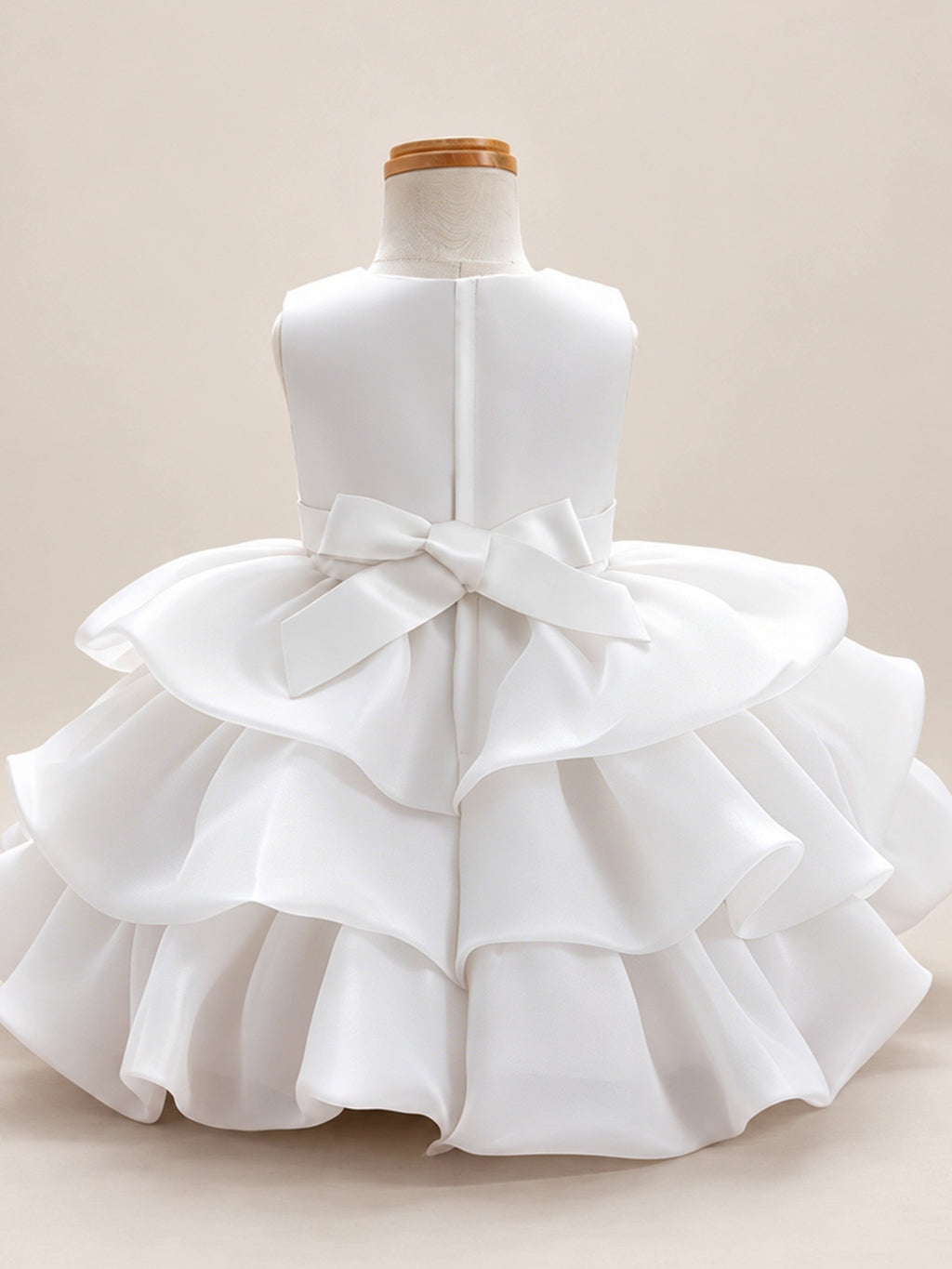 Blisseven LS8609 white girls organza tiered short princess dress back view, featuring a smooth satin bodice, back bow, zipper closure, and layered organza skirt
