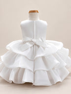 Blisseven LS8609 white girls organza tiered short princess dress back view, featuring a smooth satin bodice, back bow, zipper closure, and layered organza skirt