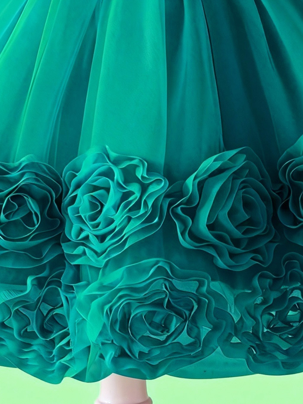 Emerald green layered tulle hem with 3D floral details on girls party dress