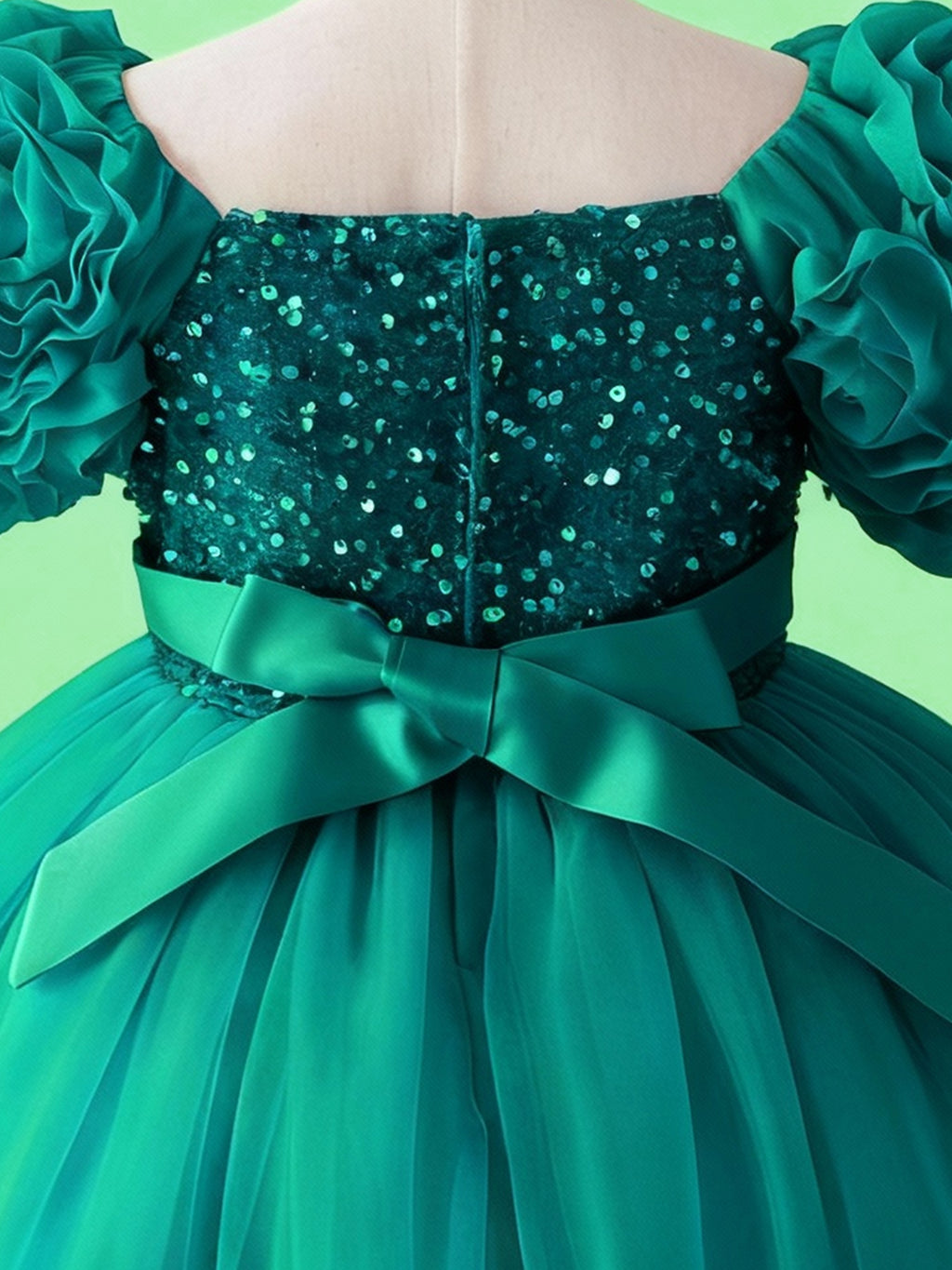 Emerald green sequin bodice and bow waist detail on girls princess dress
