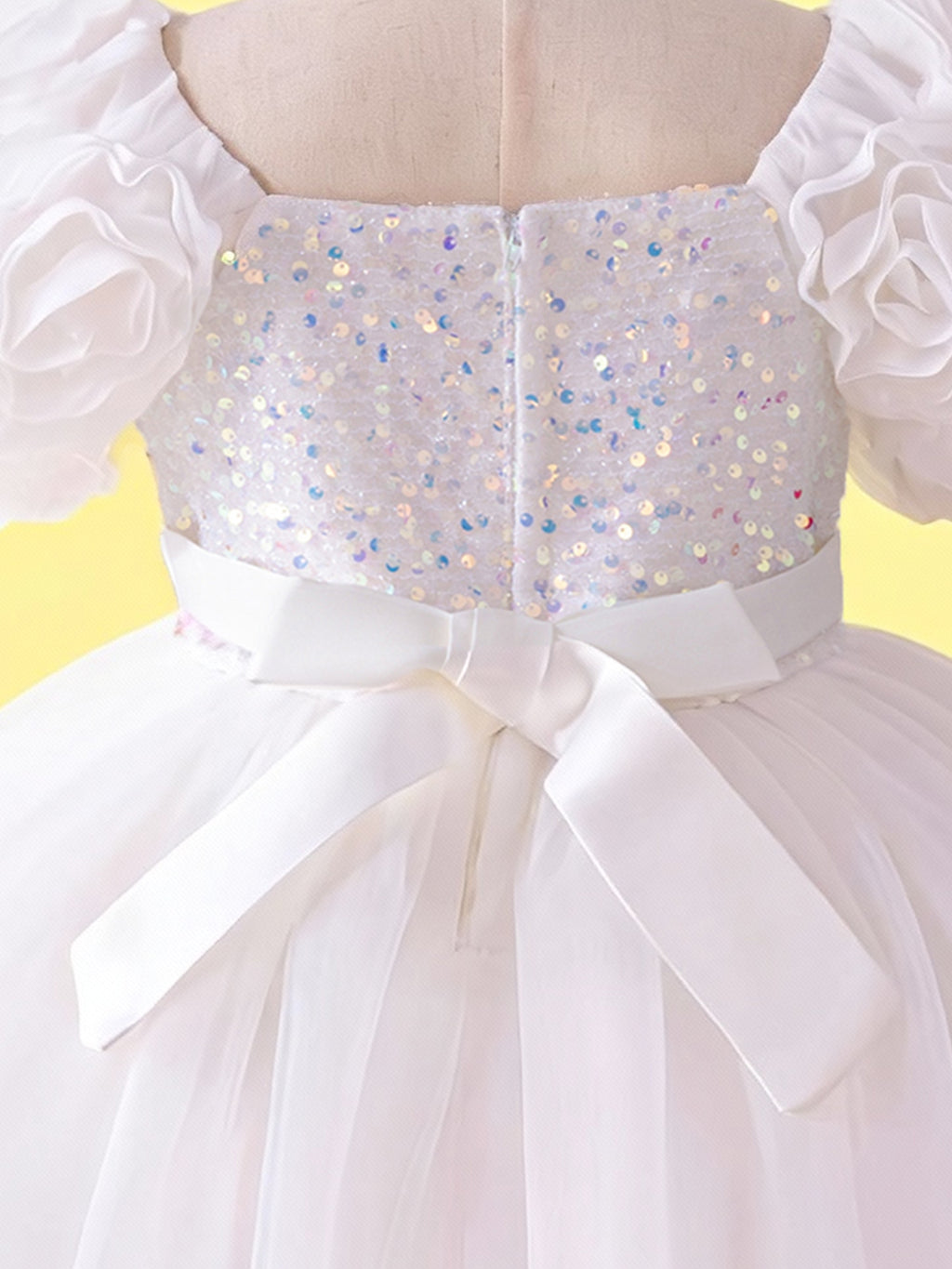 Close up of white 3D floral sleeves on girls princess dress
